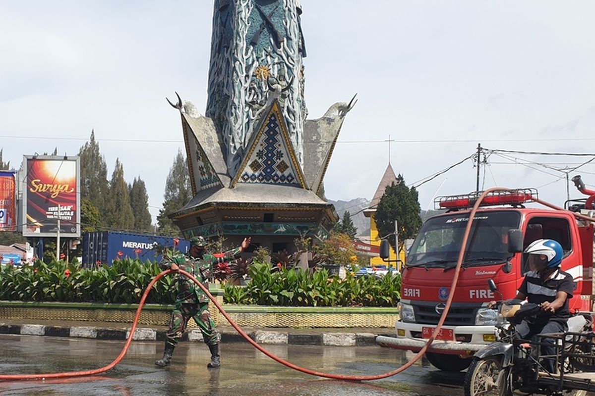 Fire and Rescue personnel clean up the main road in Berastagi following Mount Sinabung eruption in North Sumatra on Thursday morning, October 29, 2020.  