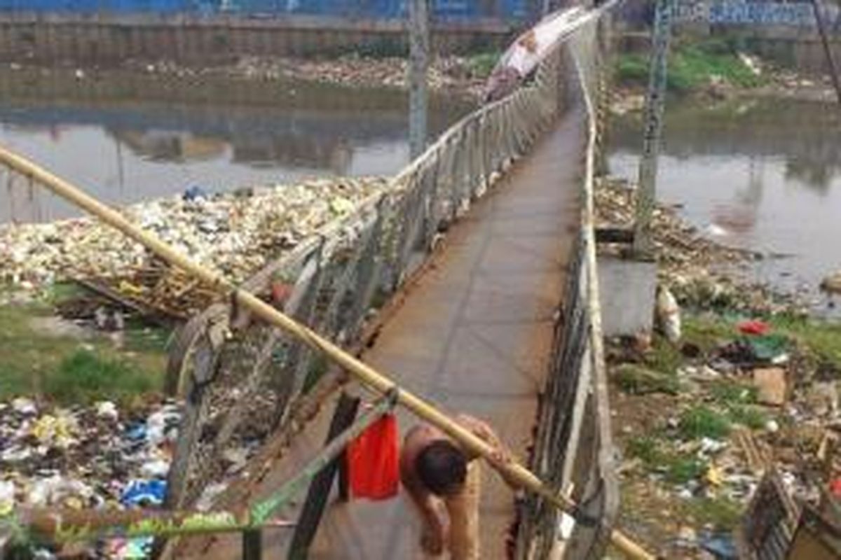 Jembatan gantung di Kanal Banjir Barat yang ambruk akibat tali slingnya putus. Foto diambil Kamis (12/6/2014). 