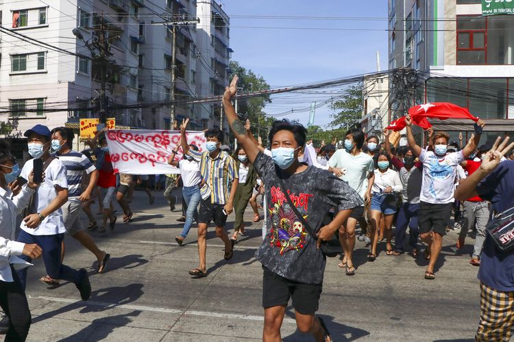 Anti-coup protesters flash the three-finger salute during a demonstration in Yangon, Myanmar, Friday, May 14, 2021. (AP Photo)