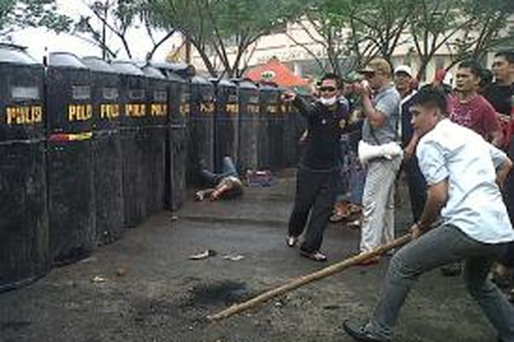Salah seorang massa pengunjukrasa terkapar setelah terkena peluru senjata api dalam bentrokan antara dengan aparat sebagai rangkaian dalam simulasi pengamanan Pemilu yang digelar di Kabupaten Bone, Sulawesi Selatan. Senin, (04/11/2013).