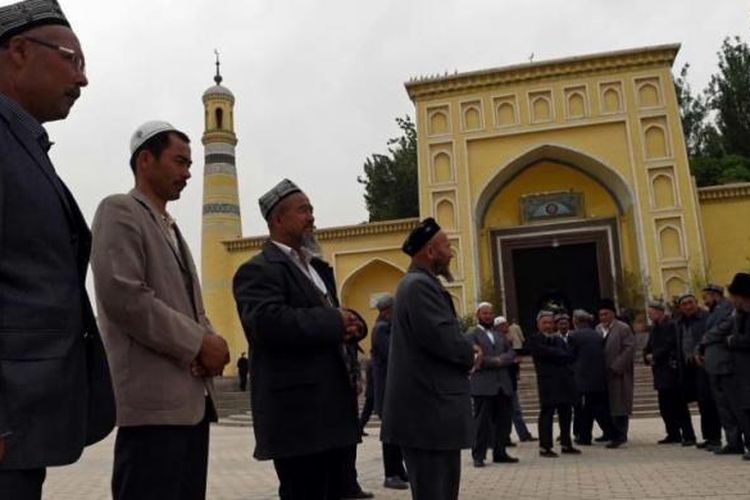 Warga Suku Uighur berkumpul usai menjalankan shalat di Masjid Id Kah di Kashgar, Xinjiang, China bagian barat, 19 April 2015. Pihak berwenang China telah membatasi ekspresi agama di Xinjiang, yang telah memicu perlawanan.