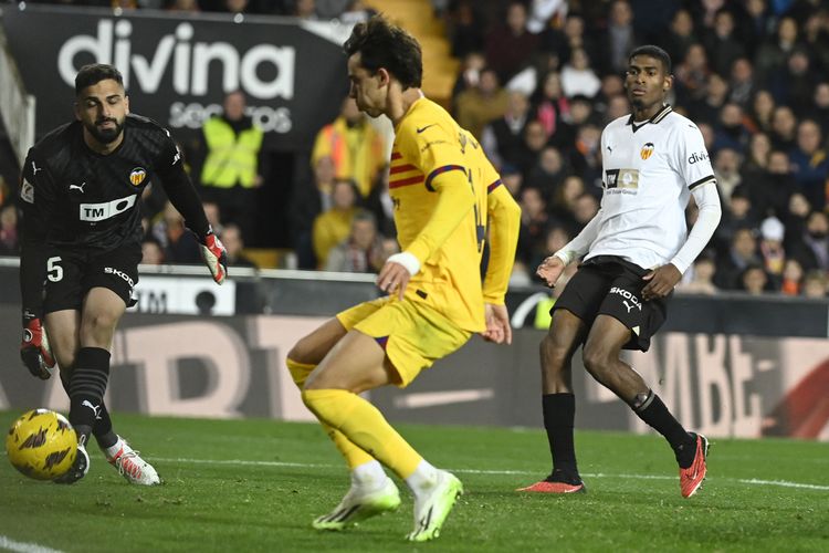 Penyerang Barcelona asal Portugal Joao Felix (tengah) mencetak gol pembuka pada pertandingan La Liga Spanyol antara Valencia vs Barcelona di Stadion Mestalla di Valencia pada 16 Desember 2023.