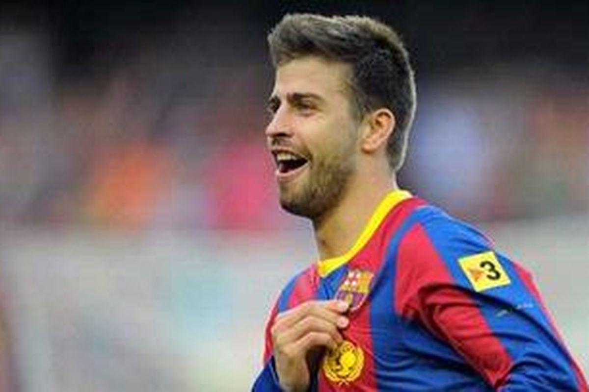 Bek Barcelona Gerard Pique merayakan golnya ke gawang Espanyol, dalam lanjutan Liga BBVA, Minggu (8/5/2011).