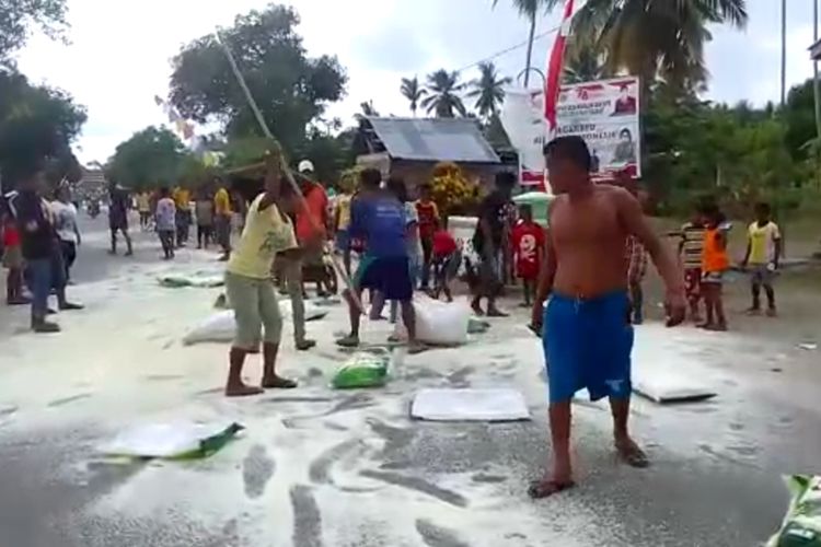 Warga di Desa Waraloin, Kecamatan taniwel Timur, Kabupaten Seram Bagian Bagat, Maluku ramai-ramai menumpah sekirar dua ton beras di jalan di depan baia desa tersebut, Sabtu (27/11/2021).