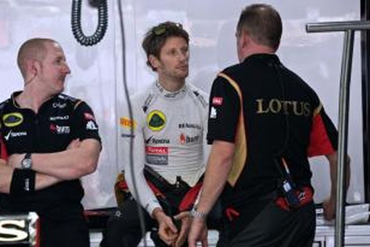Pebalap Lotus asal Perancis, Romain Grosjean (tengah) berdiskusi dengan kru di pit saat sesi latihan bebas kedua GP India di Sirkuit Buddh International, Jumat (25/10/2013).