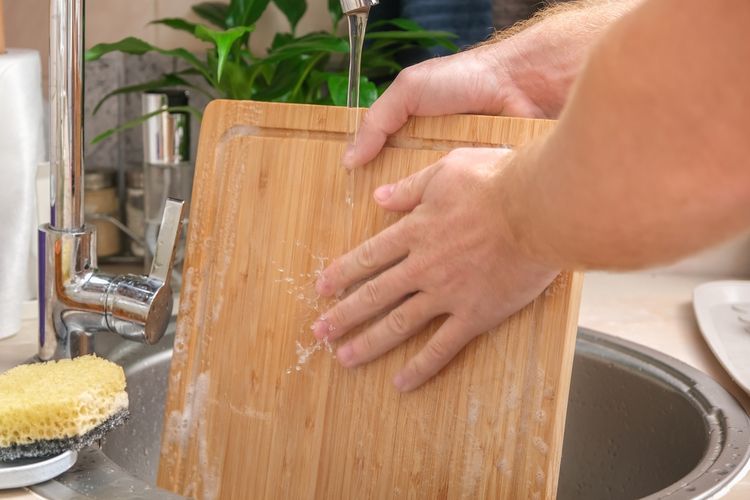 Illustration of washing a wooden cutting board, cleaning a wooden cutting board.