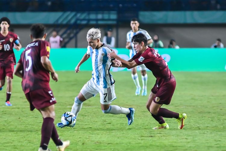 Ian Subiabre pemain Timnas U17 Argentina berusaha melepaskan diri dari kawalan pemain Venezuela pada pertandingan fase 16 besar Piala Dunia U17 2023 Indonesia antara Argentina vs Venezuela, Selasa (21/11/2023) di Stadion Si Jalak Harupat (SJH) Soreang, Kabupaten Bandung. 