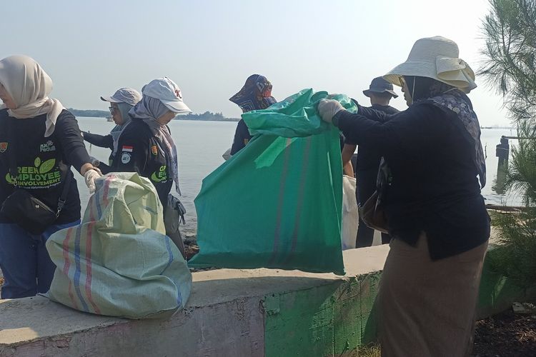 Warga membersihkan sampah di Pantai Mangunharjo Semarang, Jawa Tengah. Rabu (5/6/2024). 