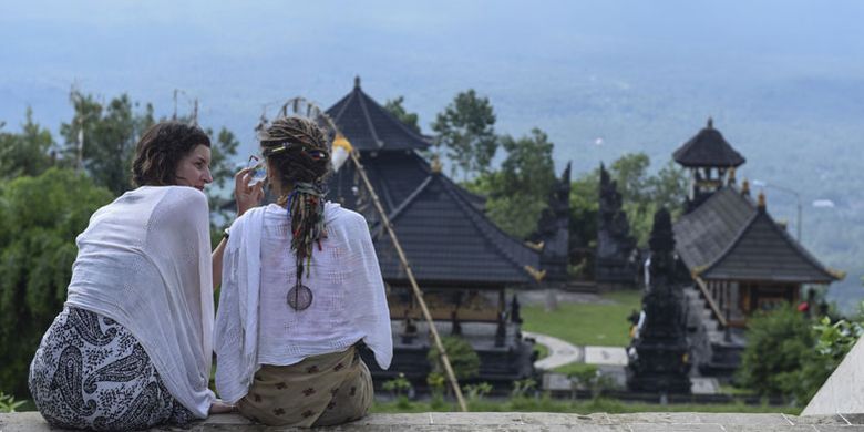 Wisatawan asing berada di Pura Lempuyang, Karangasem, Bali, Kamis (7/12/2017). Menteri Pariwisata Arief Yahya menyatakan pemerintah memangkas target kunjungan wisatawan mancanegara pada tahun ini dari 15 juta menjadi 14 juta wisatawan akibat erupsi Gunung Agung di Bali.