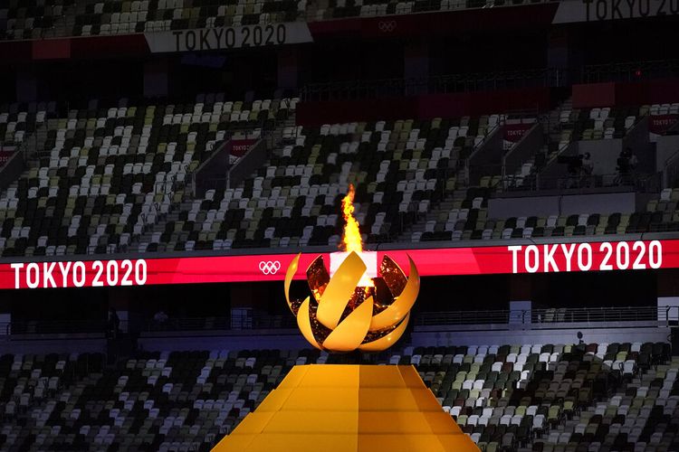 The Olympic flame burns from the cauldron during the opening ceremony in the Olympic Stadium at the 2020 Summer Olympics, Friday, July 23, 2021, in Tokyo, Japan. (AP Photo/Ashley Landis)