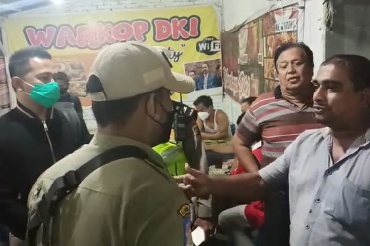 Tangkapan layar, seorang pemilik warung kopi di Medan, Sumatera Utara, menolak untuk menutup warkopnya saat didatangi petugas patroli PPKM Darurat.