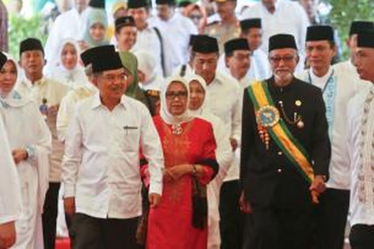 Wakil Presiden (Wapres) Jusuf Kalla (JK) didampingi Ibu Mufidah Jusuf Kalla dan Wali Nanggroe Malik Mahmud Al-Haytar tiba ditempat acara peringatan sepuluh tahun tsunami Aceh, di Lapangan Blangpadang, Banda Aceh, Jumat (26/12/2014).  