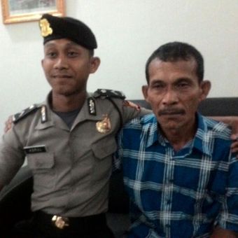Bripda Asrul (kiri), polisi muda yang mencium kaki ayahnya, Syamsuar (45), setelah resmi dilantik menjadi polisi di Sekolah Polisi Negara Batua, Sulawesi Selatan. 