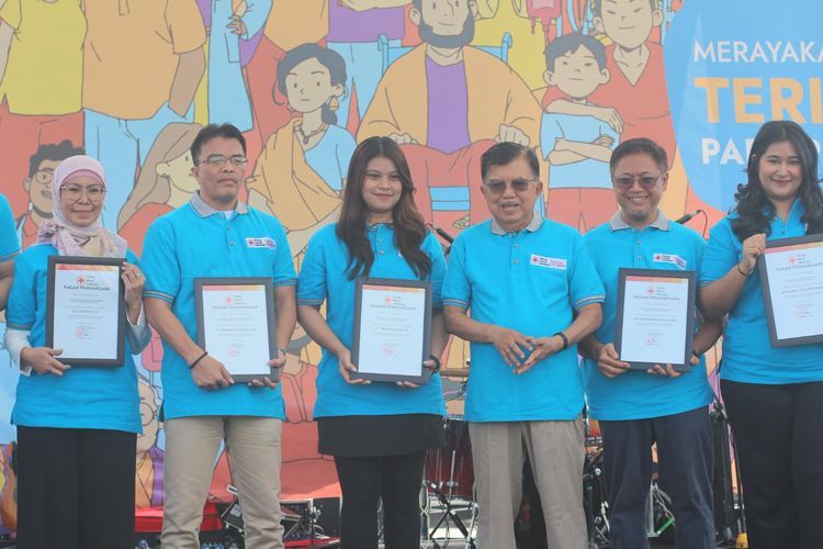 Vice President CSR Solution BCA Titi Yusnarti (kiri) menerima penghargaan dari Ketua Umum PMI Pusat Muhammad Jusuf Kalla (ketiga kanan), Minggu (14/7/2024). 