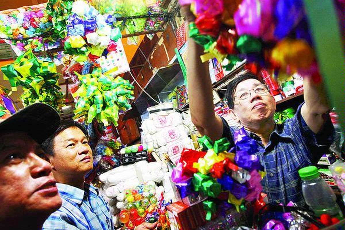 Pe d a g a n g melayani warga yang hendak membeli kulit ketupat dari pita plastik bermacam warna yang dijual di salah satu kios di Pasar Pagi Asemka, Jakarta Barat, Senin (14/9). Pernak-pernik hiasan bingkisan dan paket Lebaran itu dijual antara Rp 3.000-Rp 30.000 per lusin.