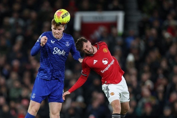 Jake O'Brien (kiri) berduel bola udara dengan Mason Mount (kanan) dalam pertandingan sepak bola Liga Inggris antara Manchester United vs Everton di Old Trafford di Manchester, barat laut Inggris, pada 24 November 2025. (Foto oleh Darren Staples / AFP)