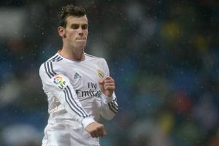 Pemain sayap Real Madrid Gareth Bale merayakan salah satu dari dua golnya ke gawang Rayo Vallecano, pada pertandingan Primera Division La Liga, di Santiago Bernabeu, Sabtu (29/3/2014). Madrid memenangi laga itu dengan skor 5-0.