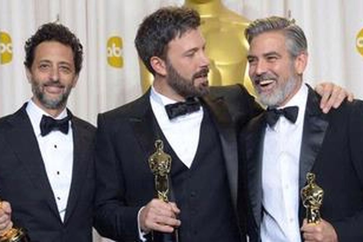 Ben Affleck (tengah), George Clooney (kanan), dan Grant Heslov merayakan kemenangan film Argo di panggung Academy Awards 2013.