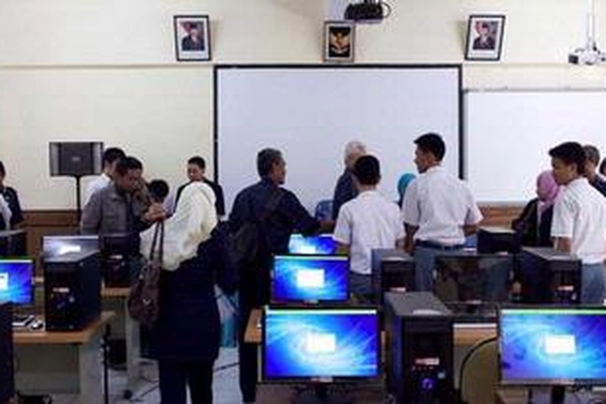 Guru yang mengikuti tes Uji Kompetensi Guru (UKG) 2012 meninggalkan ruang multimedia di SMK 26, Rawamangun, Jakarta Timur, Senin (30/7/2012). UKG gelombang pertama yang dilaksanakan pukul 08.00 WIB hingga 10.00 WIB tidak bisa berjalan karena server tidak bisa diakses. Para guru hanya bisa mengisi profil data diri, namun belum bisa mengakses soal.    