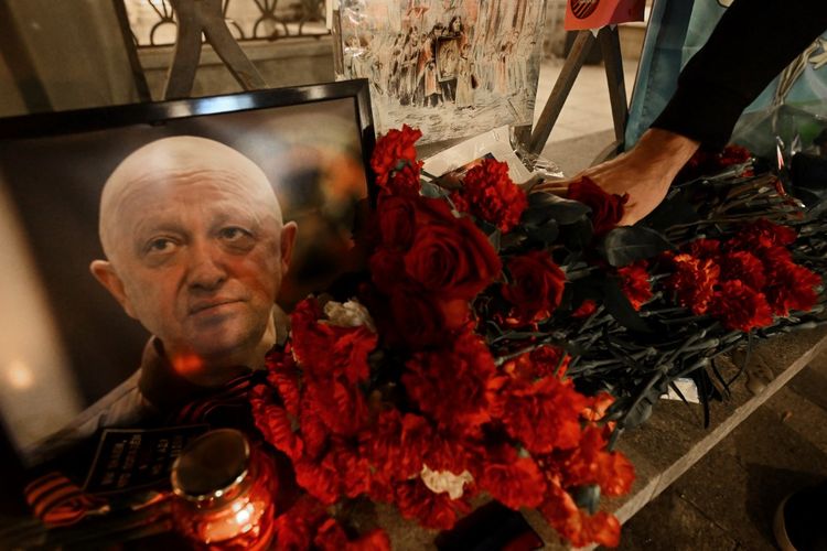 Seorang pria meletakkan bunga untuk mengenang Yevgeny Prigozhin dan Dmitry Utkin, sosok bayangan yang mengelola operasi Wagner dan diduga bertugas di intelijen militer Rusia, di Moskwa, Kamis (24/8/2023). Prigozhin tewas dalam kecelakaan pesawat yang jatuh di dekat desa Kuzhenkino, wilayah Tver, Rusia.