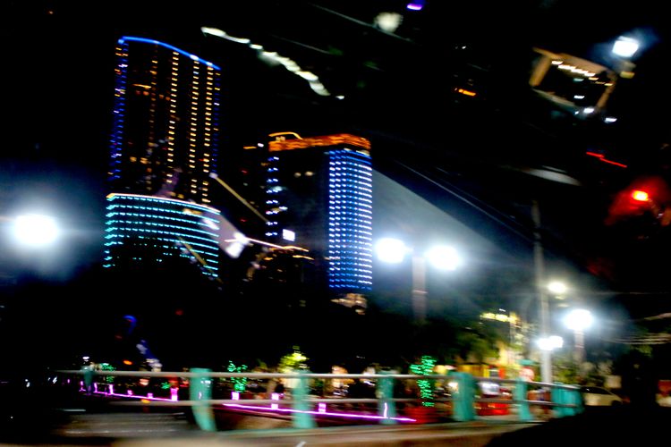 Suasana malam hari dengan background gedung yang ada di Kota Surabaya. 