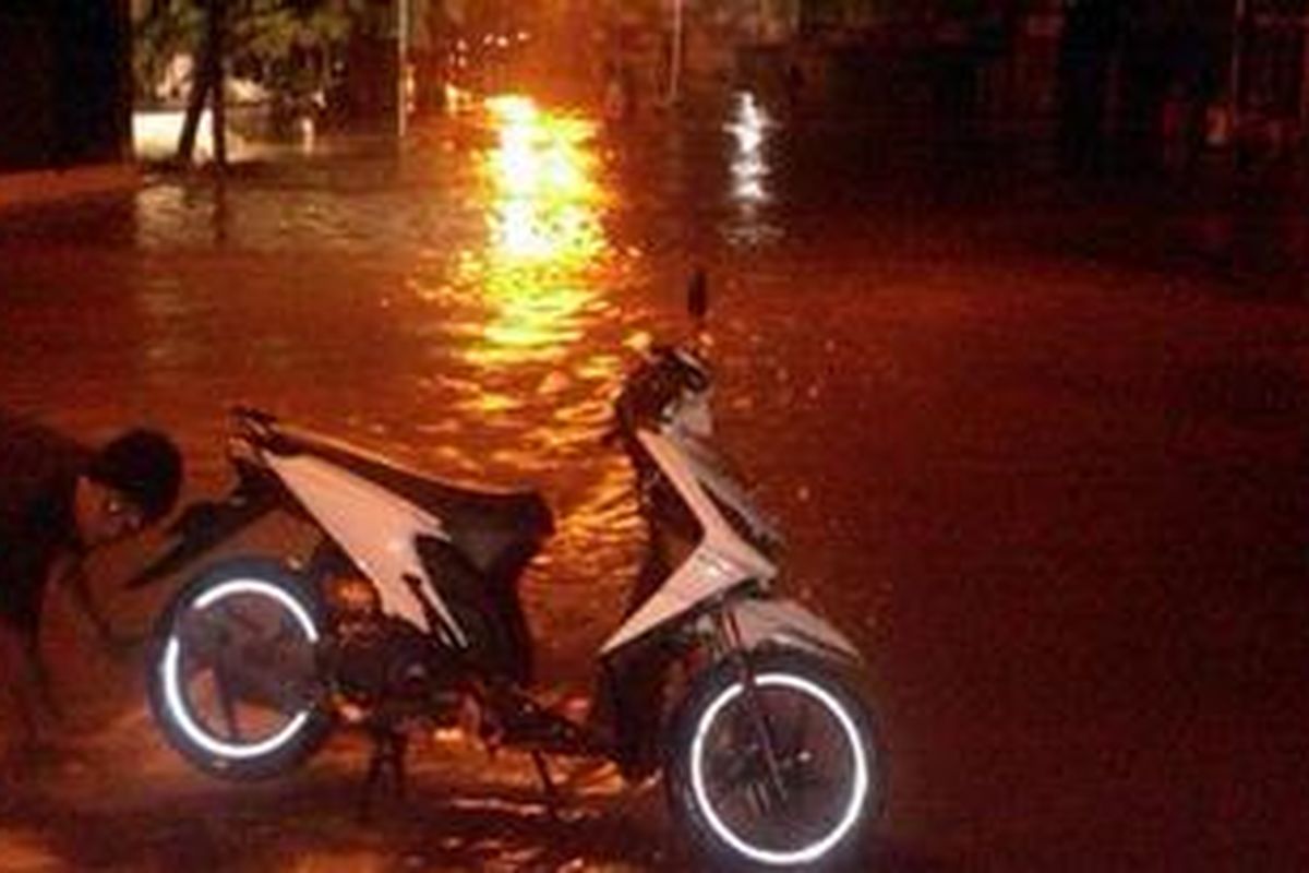 Selain merendam ratusan rumah warga bantaran, luapan Sungai Ciliwung juga masih merendam Jalan Jatinegara Barat yang mengarah ke Matraman, Jakarta Timur, Jumat (18/1/2013). Akibatnya, jalan itu tak bisa dilalui oleh kendaraan bermotor.