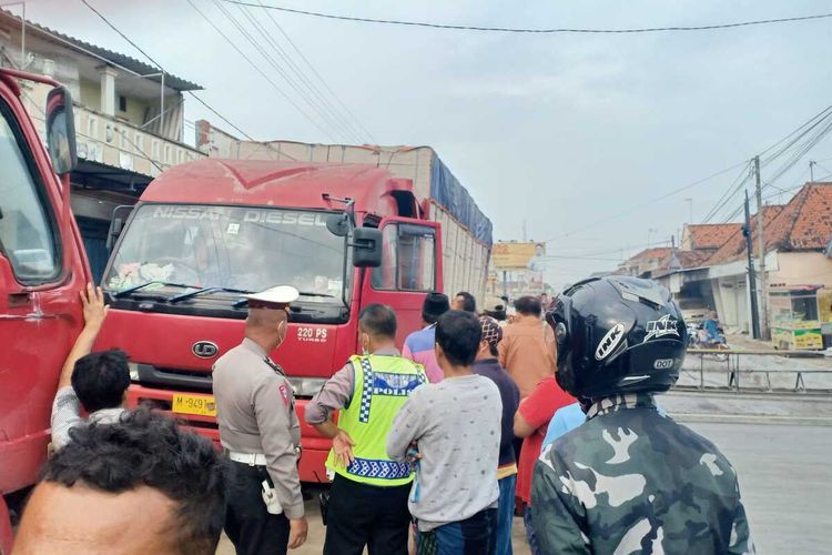 Kendaraan Truk Besar Bermuatan Batu Bata Berada di Separuh Jalan Utama Raya Blega Bangkalan Sejak Pukul 03.00 WIB, Kamis (09/12/2021).