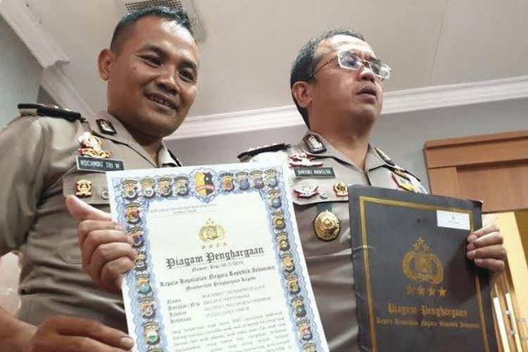 Rochmat Tri Marwoto (41) semasa hidupnya bersama Kombes Pol Frans Barung Mangera menunjukkan piagam penghargaan. Iptu Rochmat Tri Marwoto dikabarkan telah meninggal dunia.
