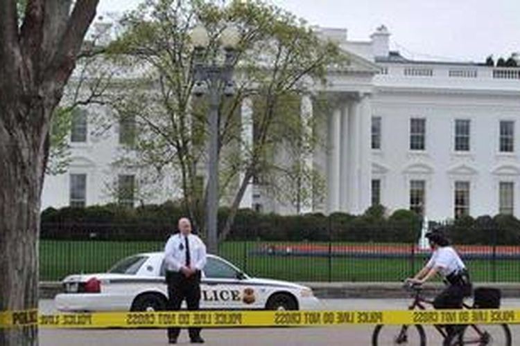 Polisi berjaga di area di depan Gedung Putih di Washington DC, AS, Senin (15/4/2013), tak lama setelah bom meledak di garis finish Boston Marathon, Boston, Massachusetts. Peristiwa itu menewaskan tiga orang dan melukai lebih dari 100 orang. 
