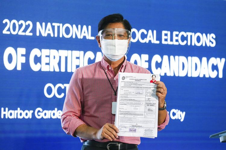 Former senator Ferdinand Bongbong Marcos Jr. poses after filing his certificate of candidacy for presidential elections with the Commission on Elections at the Sofitel Harbor Garden Tent in Manila, Philippines Wednesday, Oct. 6, 2021. The son and namesake of the late Philippine dictator Ferdinand Marcos, who was toppled in a 1986 revolt, announced Tuesday that he would seek the presidency in the 2022 elections in what activists say is an attempt to whitewash a dark period in the country's history marked by plunder and human rights atrocities. (Rouelle Umali/Pool Photo via AP)