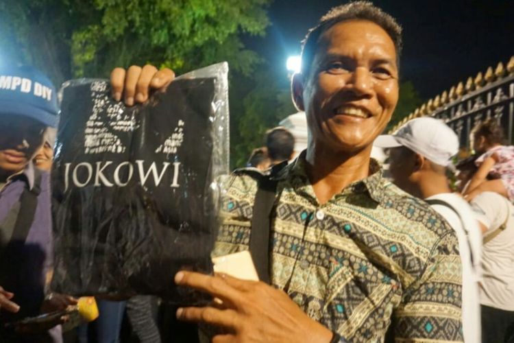 Andi Mugiono wisatawan asal Surabaya, Jawa Timur saat menunjukan kaos pemberian Presiden Joko Widodo