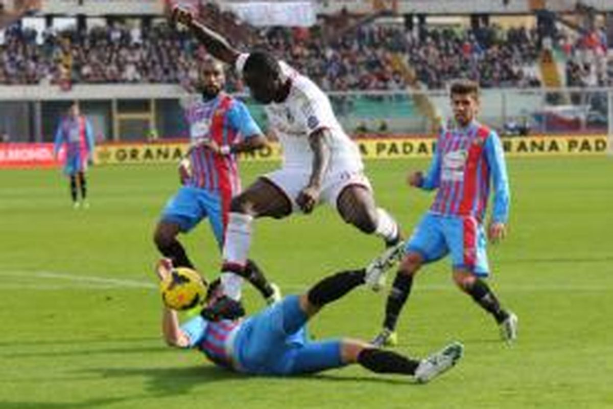 Striker AC Milan, Mario Balotelli saat berusaha merebut bola dari pemain Catania pada lanjutan Serie-A di Stadion Angelo Massimino, Minggu (1/12/2013). Milan menang 3-1 pada pertandingan tersebut. 