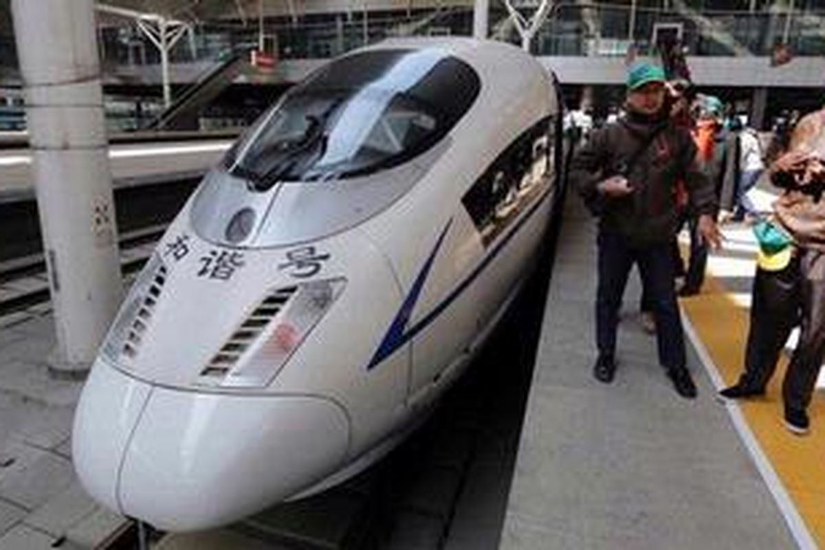 Karyawan PT KAI melihat China Railway High-Speed atau Bullet Train (Kereta Peluru) di Stasiun Tianjin di Distrik Hedong, Hebei, China, Senin (25/3/2013). Sejak 2008, stasiun ditempati kereta berkecepatan 300 km per jam yang mampu menempuh jarak 1.500 kilometer dari Beijing ke Shanghai dalam tempo lima jam.