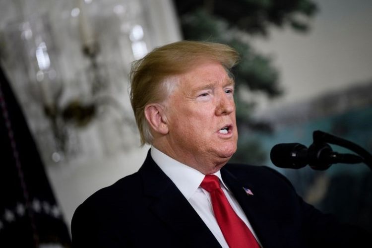 Presiden Amerika Serikar Donald Trump membuat pernyataan tentang imigrasi dan tembok perbatasan dari Gedung Putih, Sabtu (19/1/2019). (AFP/Brendan Smialowski).