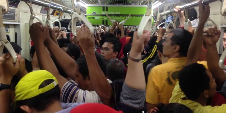 Suasana Kereta Rel Listrik (KRL) Commuter Line Jabodetabek saat jam-jam sibuk pada hari kerja. 