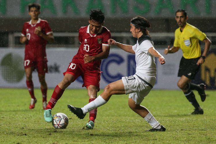 Pemain timnas U17 Indonesia Muhammad Asyura berebut bola dengan pemain timnas U17 Guam Urban Ramirez pada pertandingan Kualifikasi Piala Asia U17 2023 di Stadion Pakansari, Kabupaten Bogor, Senin (3/10/2022). Indonesia menang 14-0 atas Guam.