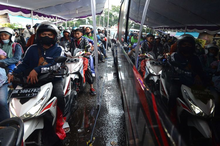 Sejumlah pemudik bersepeda motor antre untuk naik ke kapal di Pelabuhan Gilimanuk, Jembrana, Bali, Sabtu (30/4/2022). Sebanyak 33.330 unit kendaraan roda dua tercatat telah menyeberang ke Pulau Jawa melalui Pelabuhan Gilimanuk pada 22-29 April 2022 dan menjadi kendaraan yang paling banyak digunakan pemudik di Pelabuhan Gilimanuk.