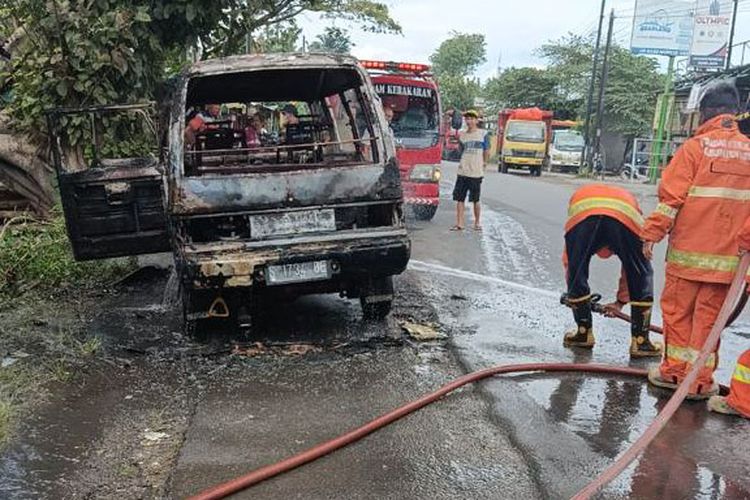 Petugas usai memadamkan api yang membakar mobil Suzuki Carry milik Warno di Jalan Raya Wringinanom, di Desa Sumengko, Kecamatan Wringinanom, Gresik, Jawa Timur, Rabu (1/3/2023).