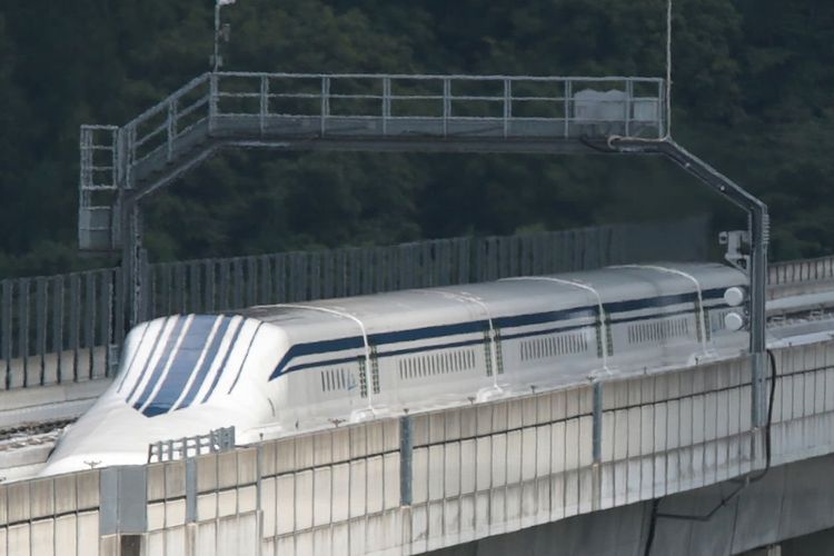 The L0 (L zero) series magnetic-levitation train, developed by Central Japan Railway Co., moves along a test track during a trial run in Tsuru City, Yamanashi Prefecture, Japan, on Thursday, Aug. 29, 2013. Japan resumed trial runs for the world's fastest magnetic-levitation train that will complement the Shinkansen bullet-train network when ready in 2027. Photographer: Yuriko Nakao/Bloomberg via Getty Images