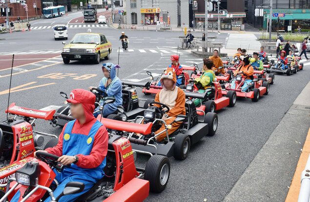 Foto yang diambil pada bulan Mei 2017 INI menunjukkan go-kart berbaris di jalan umum di Tokyo.