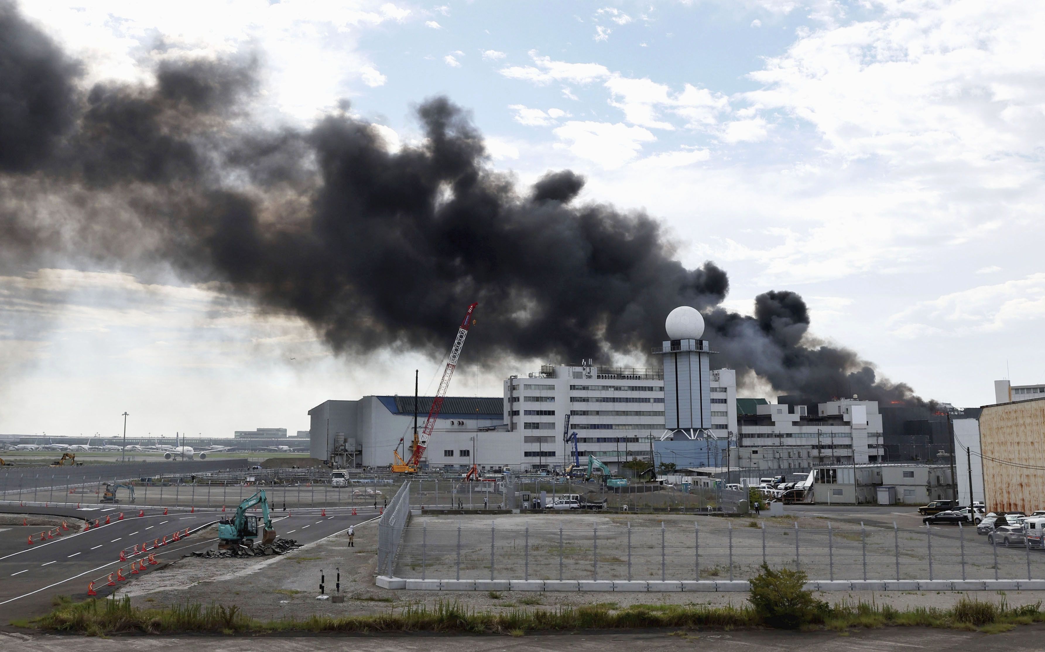 Asap hitam mengepul dari lokasi kebakaran di area yang tengah dibongkar di dekat Bandara Haneda, Tokyo, Jepang, (29/9/2025).