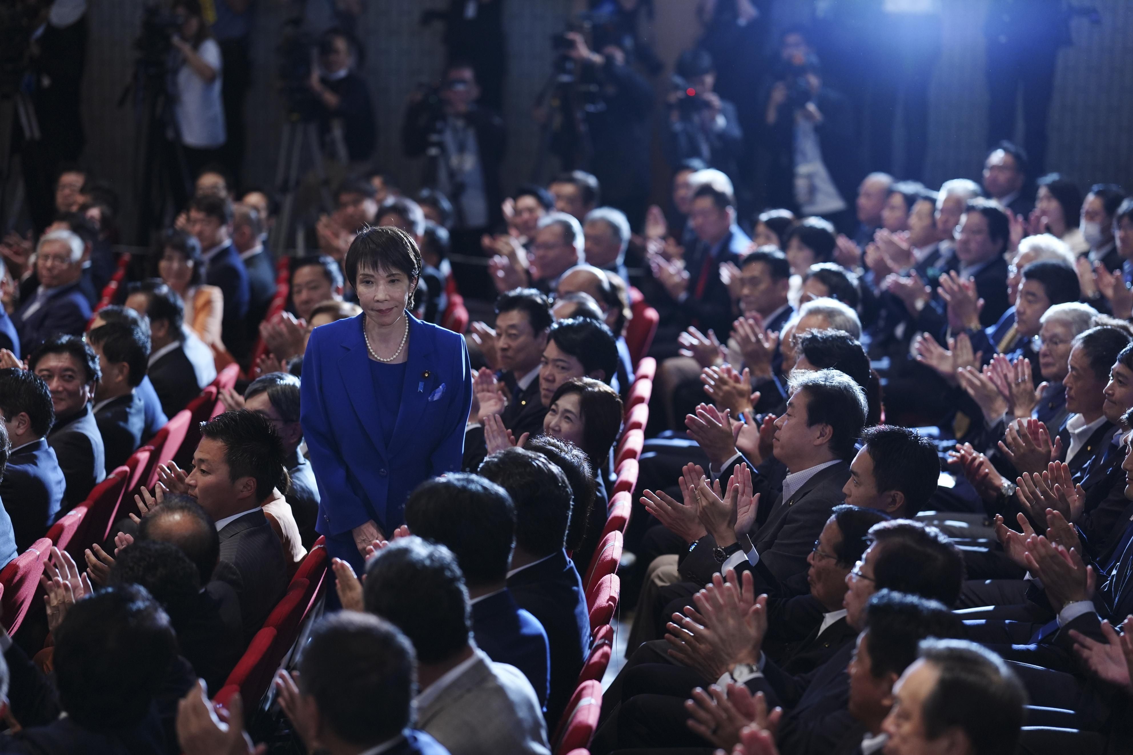 Mantan Menteri Dalam Negeri Jepang, Sanae Takaichi (tengah, berdiri), memberi salam kepada rekan-rekan sesama anggota Partai Demokrat Liberal di markas partai yang berkuasa di Tokyo pada 4 Oktober 2025, setelah memenangkan pemilihan presiden LDP melalui putaran kedua.